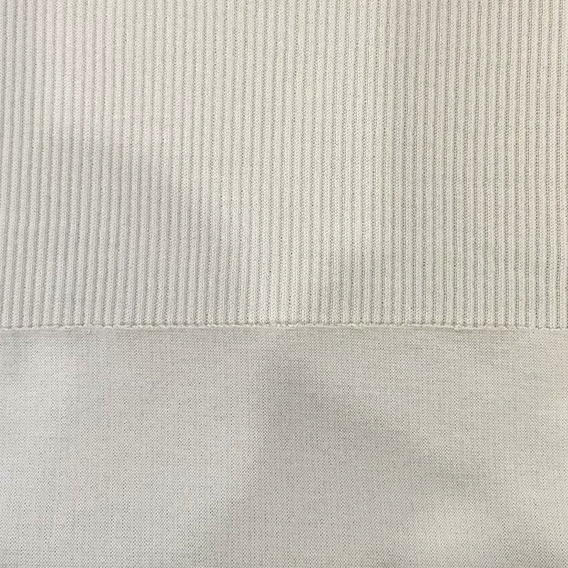 How does 100% cotton fiber perform in terms of moisture absorption and breathability, making it the material of choice for what types of clothing?